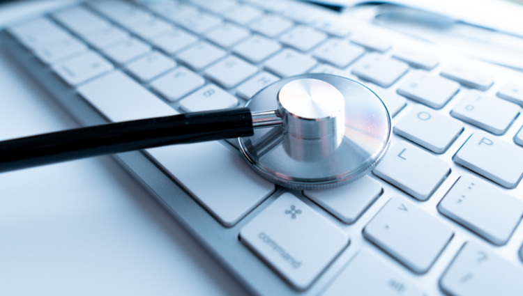 Macro view of a stethoscope on computer keyboard and key button with healthcare