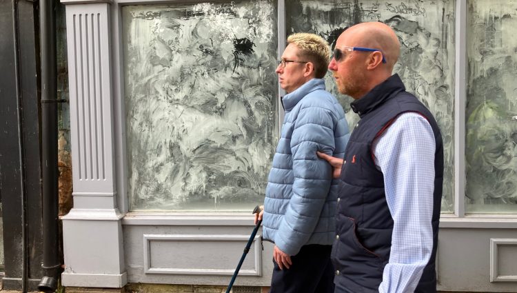 Paul Tebbitt, Policy Planner at Mansfield District Council, wearing simulation spectacles and being guided down a street to experience what it’s like to walk down a pavement with street obstacles on when living with sight loss.