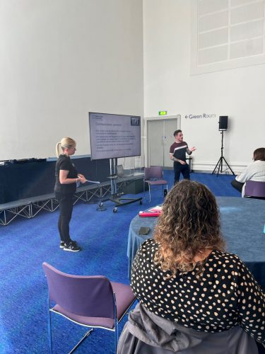 Kelly Barton and David Parfett delivering a presentation at Bridgewater Hall