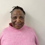 Eunice Pfupajena headshot. Eunice is wearing a light pink jumper and is smiling at the camera.